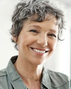 elderly woman showing her restored smile
