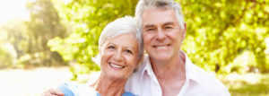 older couple smiling outside