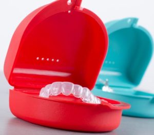 nvisalign trays in red and blue cases