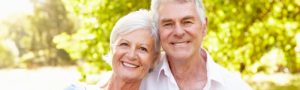 Couple smiling after dental services