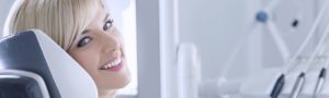 Blonde woman at dental office waiting for root canal therapy.