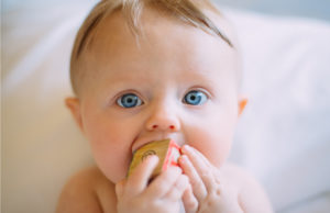 Baby chewing a wood block