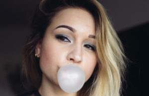 girl blowing a gum bubble