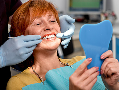 Woman In Dentist Chair Smiling