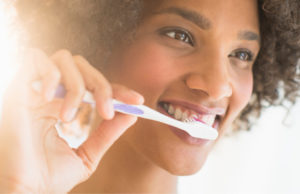 woman brushing her teeth