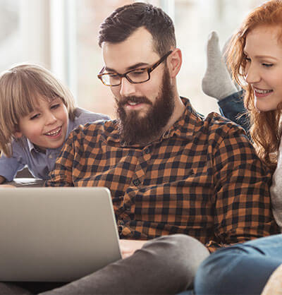 family looking at a laptop