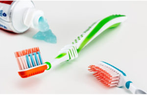 two new toothbrushes and toothpaste