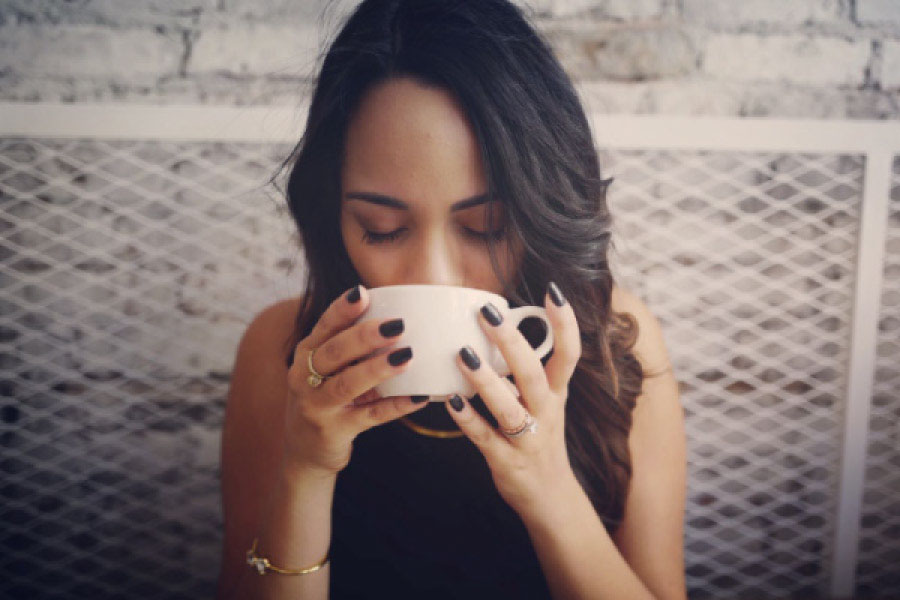 woman drinking a cup of coffee