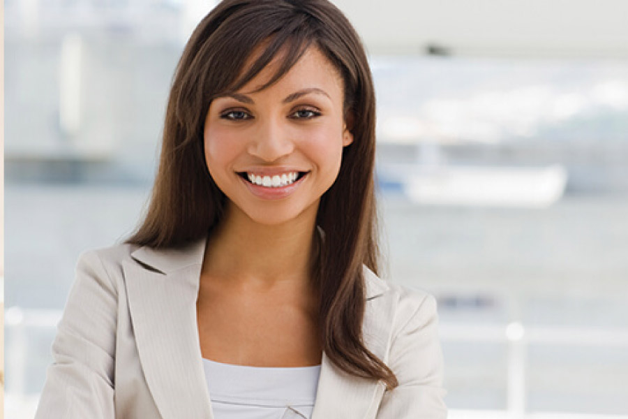 young woman smiles showing off her new dental veneers