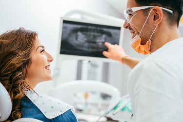 dentist showing patient xrays